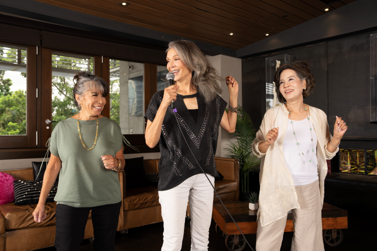 Group of senior women dancing at a karaoke party.